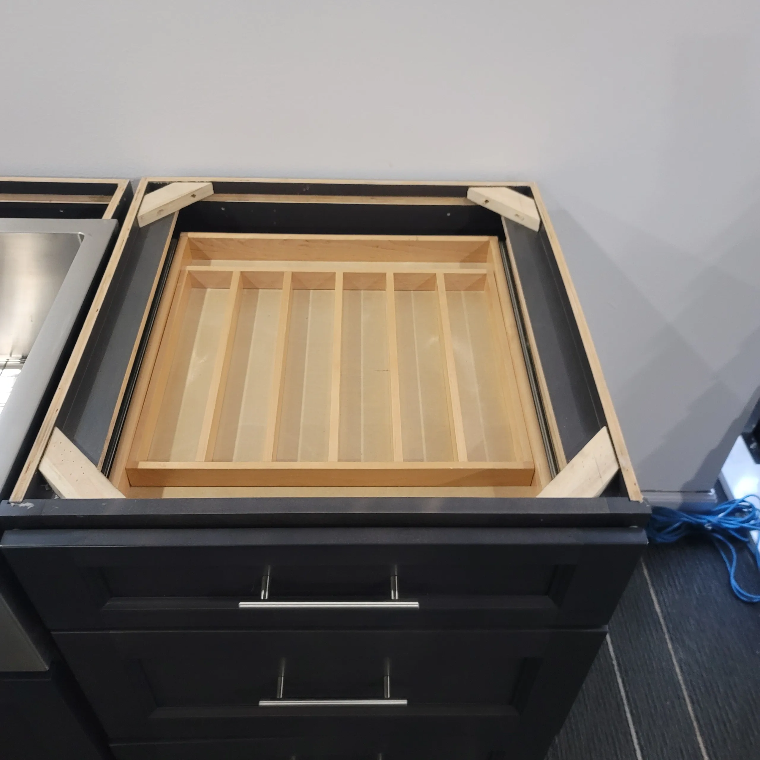 Double cutlery drawer installed in a Skokie kitchen cabinet showing the upper sliding cutlery tray pulled forward