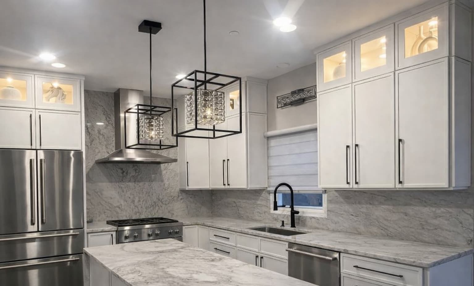 Slim Shaker Dove White kitchen cabinets installed in a Humboldt Park Chicago home – full view with pendant lighting and marble countertops